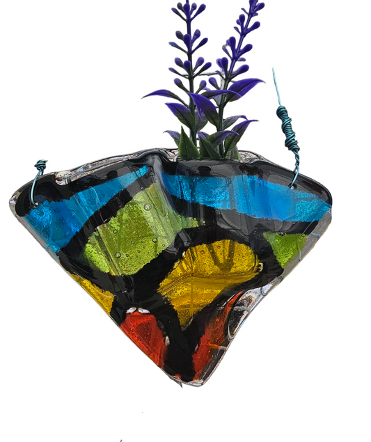 Colorful glass wall hanging with plants on a white background