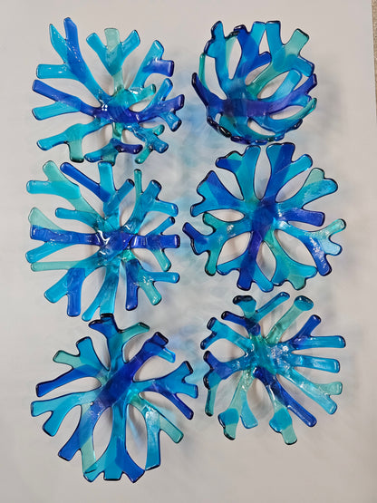 varied Coral style bowl in various shades of blue on a white surface. 