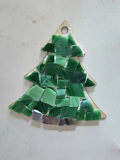 Green mosaic tree-shaped ornament on a light gray background