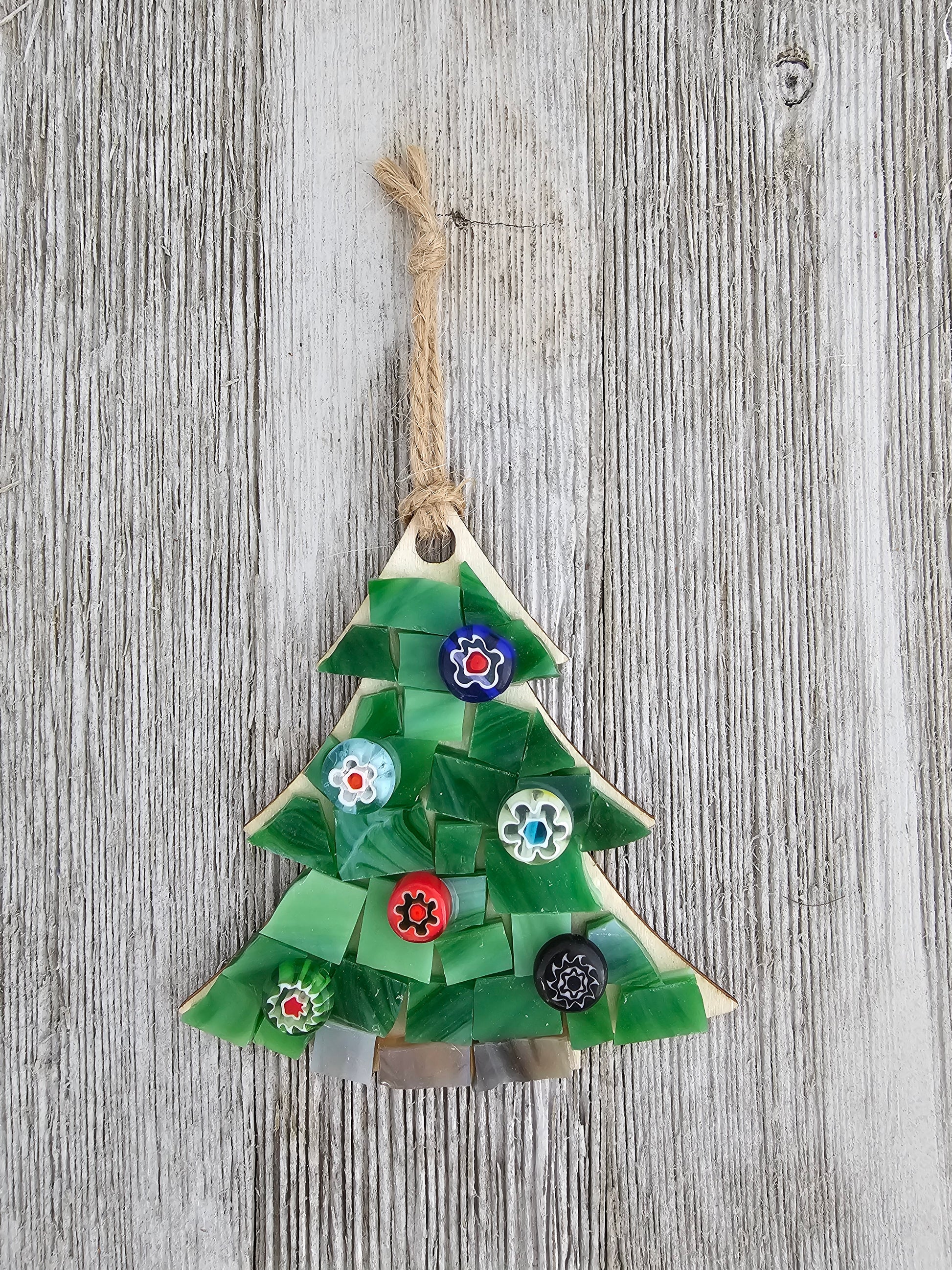 Decorative green ornament with floral patterns on a wooden surface