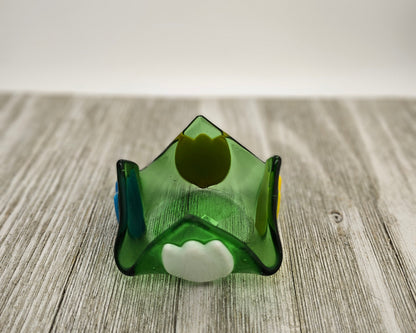 A green glass dish that comes to 4 points and has tulip of different color on each side.