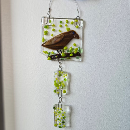 Decorative wall art that is also a suncatcher or windchime, nature and bird themed.