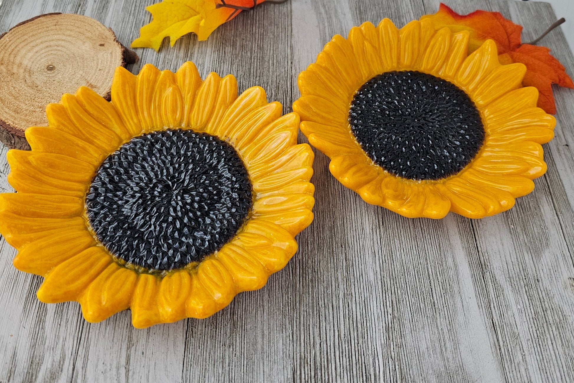 2 similar shades of sunflower. shades of yellow and orange sunflower with a dark brown center