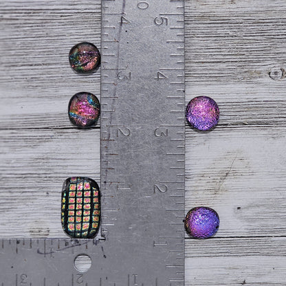 Lot of 5 dichroic glass pieces: Four pieces approx. 0.5"x0.5" and one 1"x0.5", all handmade and topped with clear glass for extra sparkle. The pieces have an organic shape due to their handmade nature. Dots come in an organza bag.