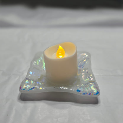 White dish with sparkle design that is displayed as a candle holder, displays a battery operated candle. 