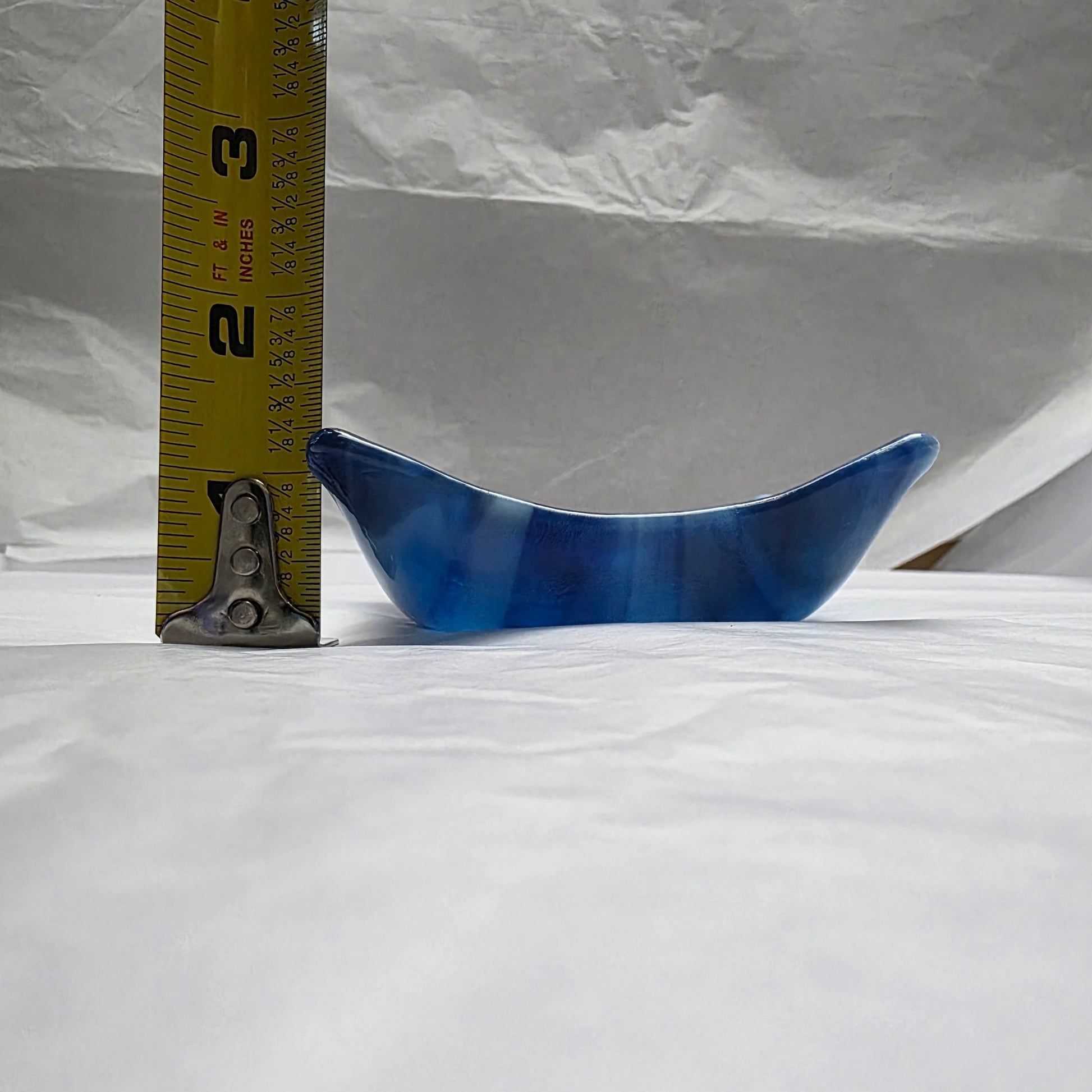 Various blue and white streaky colored little dish next to a tape measure.  Depth approximately 1.5 inches.