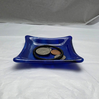 Various blue and white streaky colored little dish.  Dish is on a white surface. The little dish has coins and a hair tie indicating can be used as a trinket or ring dish.