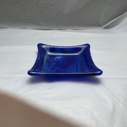 a little blue and white streaky dish on a white surface.