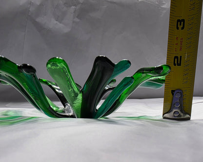 A coral inspired bowl in shades of green, sitting on a white surface. The coral bowl is being shown with a tape measure to indicate approximate size.